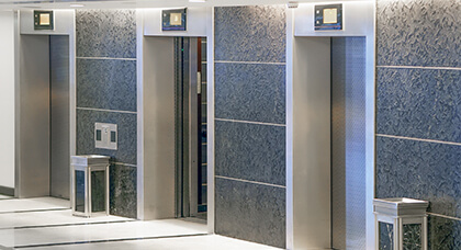 Janitorial Building Maintenance three elevator doors and standup ashtrays to illustrate our janitorial services in commercial buildings